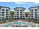 Stunning view of a modern condo complex with a sparkling pool and lush greenery at 19329 Watermark Dr # 422, Cornelius, NC 28031