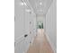 Long hallway with hardwood floors, white trim, and recessed lighting at 19329 Watermark Dr # 422, Cornelius, NC 28031
