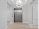 Hallway featuring hardwood floors, recessed lighting, and an elevator at 19329 Watermark Dr # 422, Cornelius, NC 28031