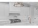 Close-up of chef's kitchen with stainless steel range, marble counters, and designer fixtures at 19329 Watermark Dr # 422, Cornelius, NC 28031