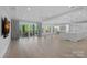 Open-concept living room with hardwood floors, a wet bar, and sliding glass doors at 19329 Watermark Dr # 422, Cornelius, NC 28031