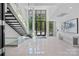 Bright lobby featuring a modern staircase, tile floors, and floor-to-ceiling windows at 19329 Watermark Dr # 422, Cornelius, NC 28031