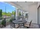 This outdoor patio offers a black table and chairs with views of green plants and buildings in the distance at 19329 Watermark Dr # 422, Cornelius, NC 28031