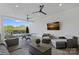 This covered patio includes a ping pong table, outdoor seating, and a wall-mounted TV at 19329 Watermark Dr # 422, Cornelius, NC 28031