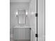 Elegant powder room featuring a vanity with marble countertop and decorative sconces at 19329 Watermark Dr # 422, Cornelius, NC 28031