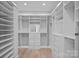 Spacious walk-in closet featuring custom shelves, drawers, and full-length mirror at 19329 Watermark Dr # 422, Cornelius, NC 28031