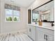 Bright bathroom with double vanity, modern fixtures, large window, and stylish tile flooring at 223 Halemarg Dr, Belmont, NC 28012