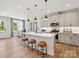 Well-lit kitchen featuring an island with seating and stainless steel appliances at 223 Halemarg Dr, Belmont, NC 28012