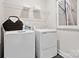 Well-organized laundry room with modern washer and dryer, wire shelving, and a stylish accent at 223 Halemarg Dr, Belmont, NC 28012