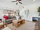 Bright living room with modern decor, fireplace, decorative mantle, open to kitchen and staircase at 223 Halemarg Dr, Belmont, NC 28012