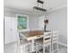 Bright dining room with a wooden table set, modern lighting fixture, and built-in storage cabinets at 232 Harmony Hills Dr, Catawba, SC 29704