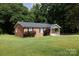 Classic brick home featuring a neat lawn and charming front porch at 232 Harmony Hills Dr, Catawba, SC 29704