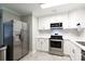 Modern kitchen featuring stainless steel appliances, white cabinetry, bright countertops, and a spacious layout at 232 Harmony Hills Dr, Catawba, SC 29704