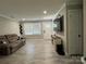 Bright living room with neutral walls, hardwood floors, large windows, and comfortable couch at 232 Harmony Hills Dr, Catawba, SC 29704