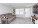 Cozy living room featuring a comfortable couch, a decorative shelf, and a well-lit front door and window at 232 Harmony Hills Dr, Catawba, SC 29704