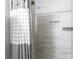 Bathroom shower with white-grey striped tiles and a rainfall shower head at 232 Harmony Hills Dr, Catawba, SC 29704