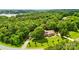 Scenic aerial view of a home nestled in a lush, wooded landscape with a lake view at 234 Rivercliff Dr, Stony Point, NC 28678
