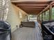 Relaxing covered back porch with comfortable seating and outdoor cooking area at 234 Rivercliff Dr, Stony Point, NC 28678