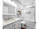 Bright bathroom featuring a tub shower combo, decorative mirror, and white cabinets at 234 Rivercliff Dr, Stony Point, NC 28678