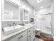 Modern bathroom with double sinks, granite countertops, and a glass-enclosed shower with a tile surround at 234 Rivercliff Dr, Stony Point, NC 28678