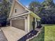 Detached garage with a large bay door and tidy landscaping at 234 Rivercliff Dr, Stony Point, NC 28678