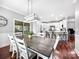 Elegant dining room with a large wooden table and stylish light fixture overlooking the kitchen at 234 Rivercliff Dr, Stony Point, NC 28678