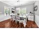 Bright dining room featuring a farmhouse table, chandelier lighting, and large windows at 234 Rivercliff Dr, Stony Point, NC 28678