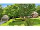 Exterior view of the property, showcasing the brick home, detached garage, and lush green lawn at 234 Rivercliff Dr, Stony Point, NC 28678