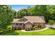 Charming brick home featuring a landscaped front yard, covered porch, and well-manicured shrubbery at 234 Rivercliff Dr, Stony Point, NC 28678