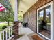 Inviting front porch featuring brick accents, a welcoming 'welcome' mat, and outdoor seating at 234 Rivercliff Dr, Stony Point, NC 28678