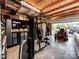Garage features overhead lighting, pegboard, work-out equipment, and roll-up door at 234 Rivercliff Dr, Stony Point, NC 28678