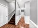 Inviting hallway with hardwood floors and staircase leading to the upper level at 234 Rivercliff Dr, Stony Point, NC 28678