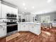 Bright and modern kitchen featuring stainless steel appliances and white cabinetry and countertops at 234 Rivercliff Dr, Stony Point, NC 28678