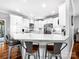 Spacious kitchen with white cabinets, stainless steel appliances, and a marble-topped island with bar seating at 234 Rivercliff Dr, Stony Point, NC 28678