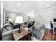 Cozy living room offering hardwood floors, comfortable seating, and plenty of natural light from large windows at 234 Rivercliff Dr, Stony Point, NC 28678