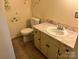 Bathroom with yellow vanity and countertop, standard toilet, and decorated wall at 237 Antietam Rd, Statesville, NC 28625