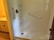 Bathroom with a shower stall featuring grab bars and built in shelves at 237 Antietam Rd, Statesville, NC 28625