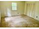 Bedroom with neutral walls and carpet, a double door closet, and a window offering natural light at 237 Antietam Rd, Statesville, NC 28625