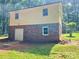 Siding with brick foundation is shown with a white door to the basement at 237 Antietam Rd, Statesville, NC 28625
