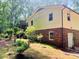 Back exterior view of home with mature landscaping and siding with brick foundation at 237 Antietam Rd, Statesville, NC 28625