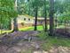 View of the exterior of home with brick and siding, nestled among mature trees at 237 Antietam Rd, Statesville, NC 28625
