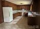 Traditional kitchen with wood cabinets, white refrigerator, and tile flooring at 237 Antietam Rd, Statesville, NC 28625
