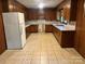 Traditional kitchen with wood cabinets, white refrigerator, and tile flooring at 237 Antietam Rd, Statesville, NC 28625