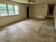 Spacious living room with large windows, carpet, and plenty of natural light at 237 Antietam Rd, Statesville, NC 28625