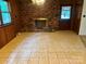 Living room featuring a brick fireplace, a window and tile flooring at 237 Antietam Rd, Statesville, NC 28625