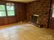 Living room featuring a brick fireplace, a window and tile flooring at 237 Antietam Rd, Statesville, NC 28625