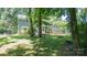 View of the home's exterior with a fire pit and a large backyard at 3008 Heathcroft Ct, Charlotte, NC 28269