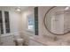 Elegant bathroom featuring a marble countertop vanity, modern fixtures, and stylish cabinets with glass accents at 3008 Heathcroft Ct, Charlotte, NC 28269
