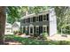 Classic two-story home featuring black shutters, beautiful landscaping, and ample natural light, on a sunny day at 3008 Heathcroft Ct, Charlotte, NC 28269