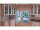 Bright kitchen featuring white cabinets, an outdoor view, and hardwood flooring at 3008 Heathcroft Ct, Charlotte, NC 28269
